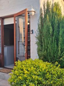 a front door of a house with bushes at 5Viooltjie in Riversdale