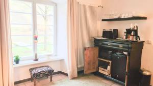 a kitchen with a dresser and a window at Mosel-Side Junior Suite in Reil