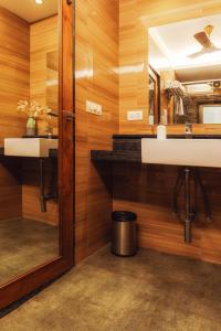 a bathroom with two sinks and a mirror at Merlot Suites in Porvorim