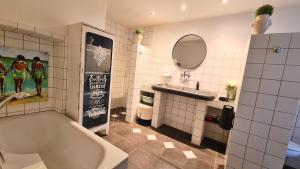 a bathroom with a tub and a sink and a mirror at Mosel-Side Junior Suite in Reil +14 photos