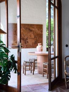 a room with a table and chairs and a table with a vase at Casa Richello in Parcent +21 photos