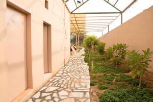 a walkway in a building with a glass roof at مزرعة أبو رامي ملعب كرة قدم ومسبح وألعاب مائية ومجالس واسعة in Al Kharj