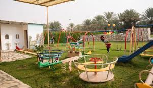 a playground with many different types of play equipment at مزرعة أبو رامي ملعب كرة قدم ومسبح وألعاب مائية ومجالس واسعة in Al Kharj