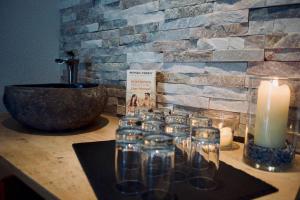 a group of glasses on a counter with a candle at Birg 1414 in Warth am Arlberg +34 photos
