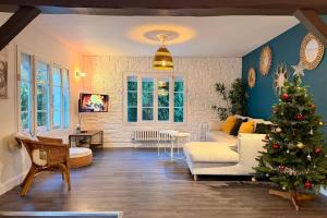 a living room with a christmas tree in it at Les Sablons in La Houssaye-en-Brie +44 photos