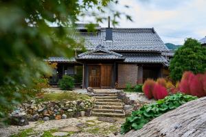 a house with a stone path in front of it at 1日1組限定の宿 旅館 土と糸 Ryokan Tsuchi to Ito in Omi