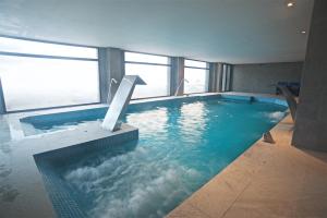 a large swimming pool with water in a building at Grand Hotel Caviahue in Caviahue