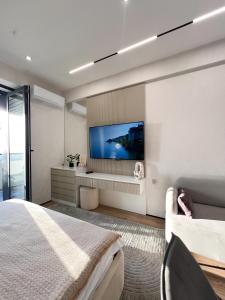 a bedroom with a large television on a wall at NRG U- Tower in Tashkent