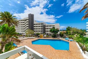 a swimming pool in front of a large building at Costa Dreams Costa Adeje in Costa de Adeje