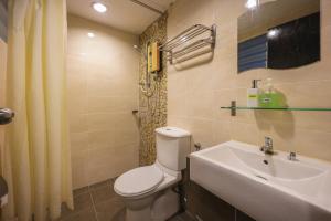 a bathroom with a toilet and a sink at Marina Island Lumut 3 Bedroom Holiday Apartment in Lumut +15 photos