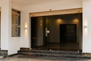 a large glass window on a building with stairs at Soni's Mansion-100m from Khajuraho Temples in Khajurāho