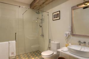 a bathroom with a shower and a toilet and a sink at Ridee Kandy in Kandy +26 photos