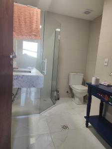 a bathroom with a shower and a toilet and a sink at A casa da Floresta in Florianópolis