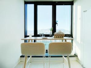 a table and two chairs in a room with a window at 엠지스테이 서면 Mzstay Modern Hotel in Seomyeon in Busan +14 photos