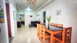 a dining room and living room with a table and chairs at Isla Vida Apartments in Bantayan Island