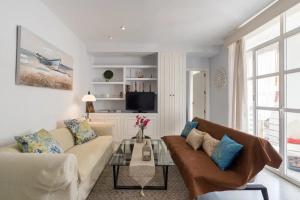 a living room with a couch and a table at Charming Apartment in Malaga - 70 m² with Balcony in Málaga
