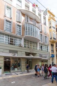 a group of people standing outside of a building at Charming Apartment in Malaga - 70 m² with Balcony in Málaga