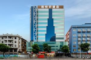 a tall glass building with a skyscraper at Park Hyatt Hotel in Taiping