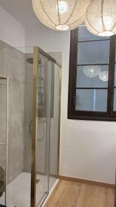 a bathroom with a shower with a glass door at Alojamiento en Ribadesella in Ribadesella