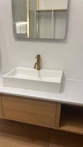 a bathroom with a white sink and a mirror at Alojamiento en Ribadesella in Ribadesella