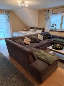 a living room with a couch and a bed at LenaVi's Fewo Nähe Europa Park & Rulantica in Kippenheim