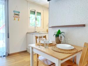 a dining room with a table with plates and glasses at DOMuum Holidays - DELFOS in Salou +25 photos