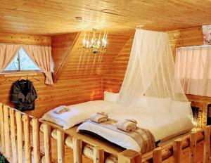 a bedroom with two beds in a log cabin at Aso Dream Villa - Vacation STAY 17297 in Okurabaru