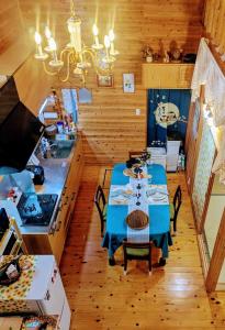 a dining room with a blue table and a kitchen at Aso Dream Villa - Vacation STAY 17297 in Okurabaru