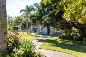 a walkway through a park with trees and grass at Sandi-Lee's Casa Bella in Plettenberg Bay