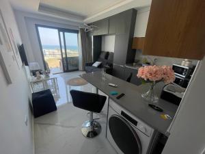 a kitchen with a counter with a vase of flowers on it at Studıo Iskele 150 in Aglantzia
