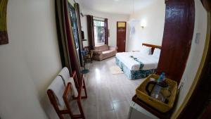 Postel nebo postele na pokoji v ubytování Sandmark Hotel Serengeti Ltd