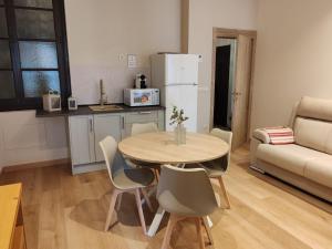 a kitchen and dining room with a table and chairs at alojamiento premium Ribadesella 2 dorm in Ribadesella +4 photos