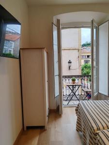 a bedroom with a door open to a balcony at alojamiento premium Ribadesella 2 dorm in Ribadesella
