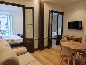 a living room with a couch and a table at alojamiento premium Ribadesella 2 dorm in Ribadesella