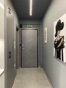 a hallway with a door and a painting on the wall at Crystal Grey Elite Apartment 2 in Serres