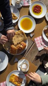a table with plates of food on it at Sahara Lounge in Tozeur