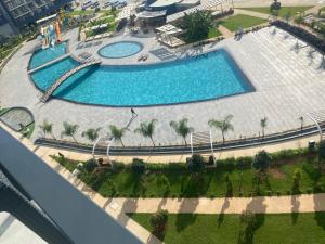 an overhead view of two swimming pools with palm trees at Studıo Iskele 150 in Aglantzia