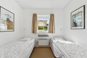 Feriehus 1145 في سوندرفيغ: سريرين في غرفة بها نافذة +25 صورة