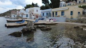 a group of chairs sitting on a dock in the water at Ponente in Symi