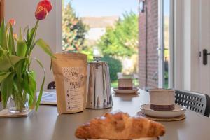 a table with a pastry on a table with a window at Exeter Heights - Short Stays UK Ltd in Exeter