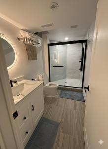 a bathroom with a toilet and a sink and a shower at Luxury, Brand-new, Specious, 2-Bedroom Apartment in Richmond Hill +24 photos