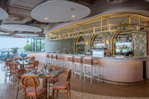 a restaurant with tables and chairs and a bar at Andaz Dubai The Palm, By Hyatt in Dubai