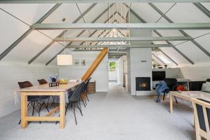 a living room with a table and a fireplace at Feriehus 1133 in Ringkøbing +16 photos