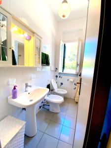 a white bathroom with a sink and a toilet at Villa Flower Holiday Torre Canne - 5min dalla spiaggia in Torre Canne +40 photos