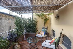 a patio with two chairs and a table at Casa Botticelli in Florence