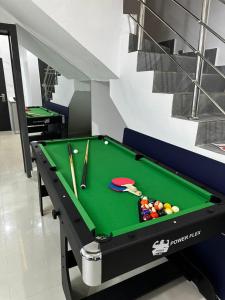 a pool table with billiard balls on it at Modern 3-Bedroom Luxury Home in Lekki Phase 1 in Lekki