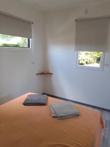 a bedroom with a bed with two towels on it at Tiny House Potrero Cba in Potrero de Garay