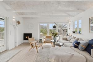 a living room with a couch and a fireplace at Feriehus 1142 in Ringkøbing