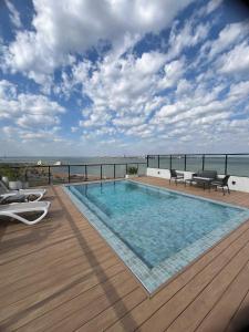 a swimming pool on a deck with a view of the ocean at Refugio de lujo Piscina con Vistas panorámicas in Encarnación
