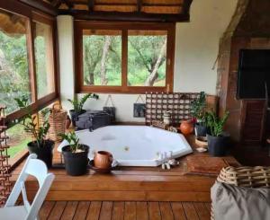 a bath tub in a room with potted plants at RSM Country Estate Unit 2 in Nelspruit